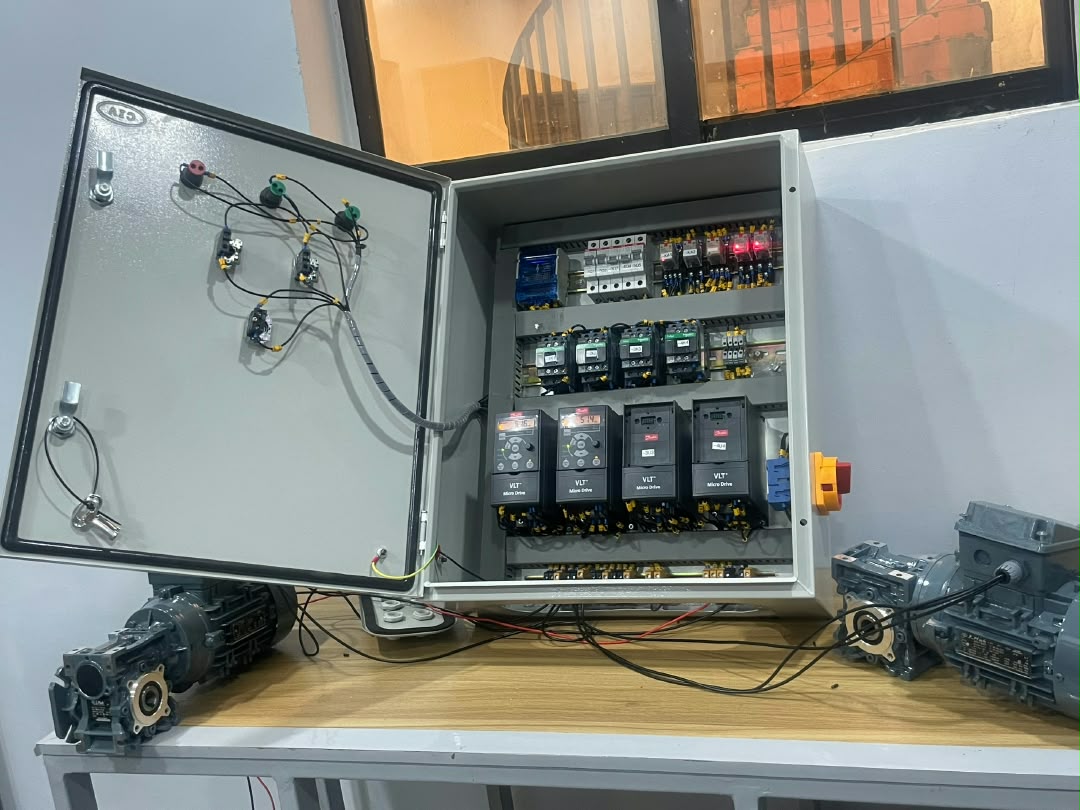 Completed conveyor control panel with VFDs and motor components